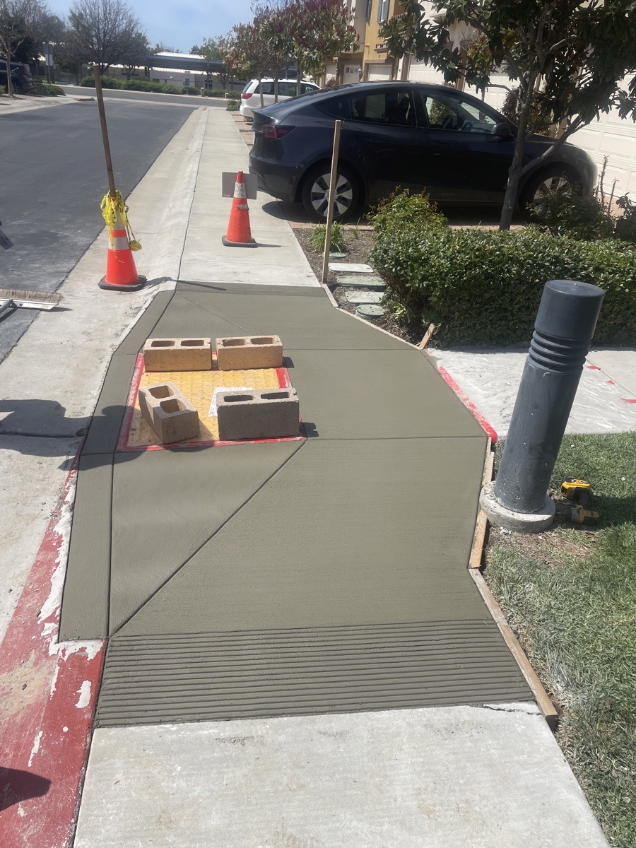 Close view of a fresh concrete transition edge and retained adjoining surfaces